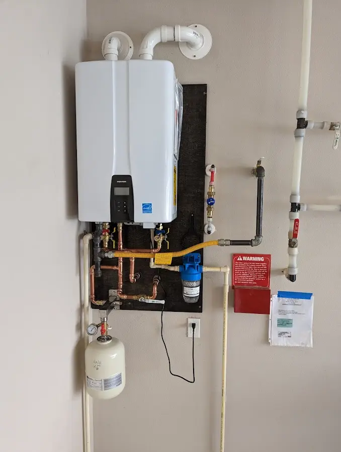 Professional plumber installing copper piping in a Silver Hill home